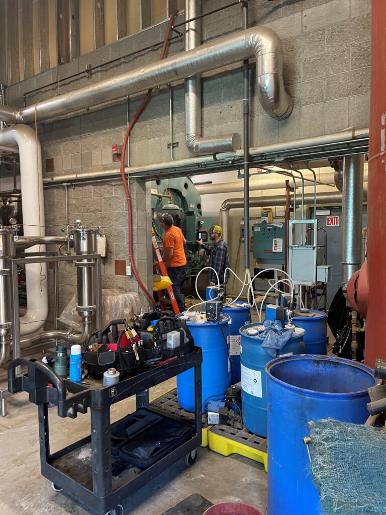 Two man inspecting a Boiler.